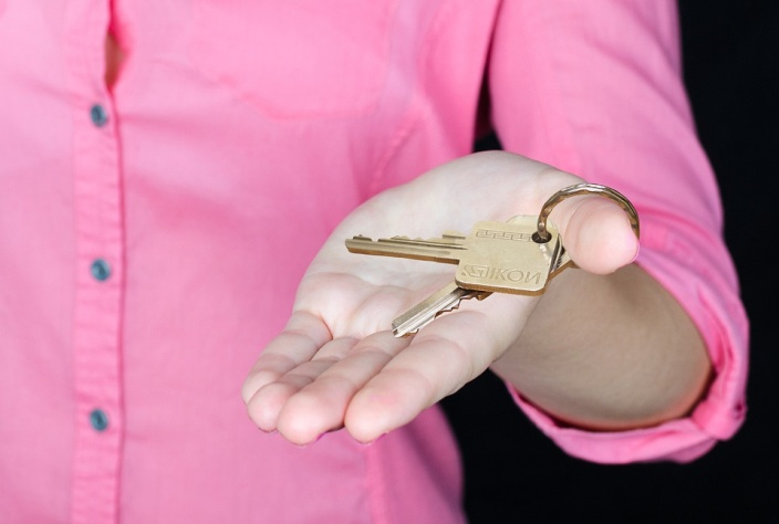 A landlord holding keys to his property