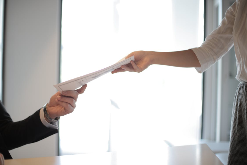 Person handing documents to a renter