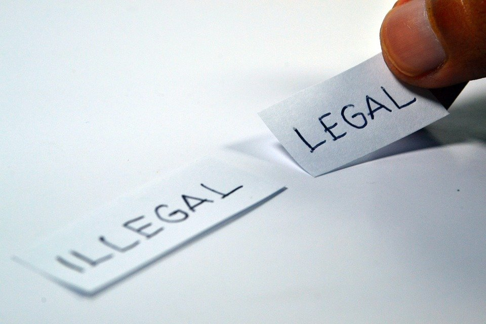 a person holding a piece of paper that says, 'legal'